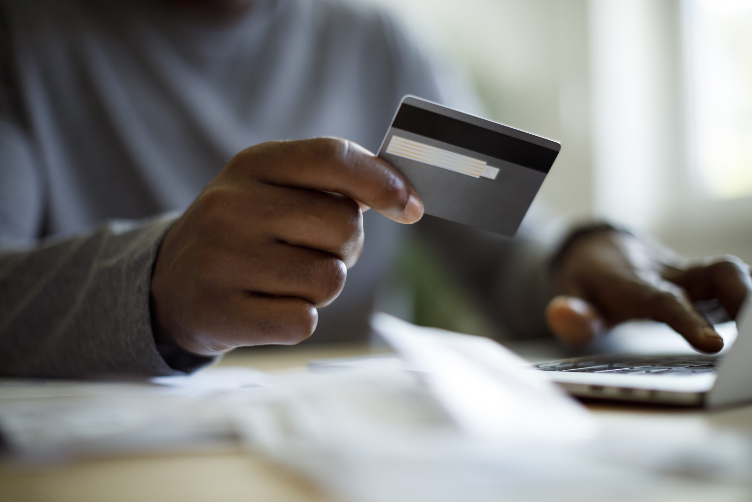 Man Using A Credit Card To Pay Bills